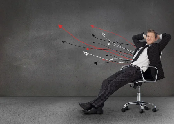 Smiling businessman resting in a chair — Stock Photo, Image