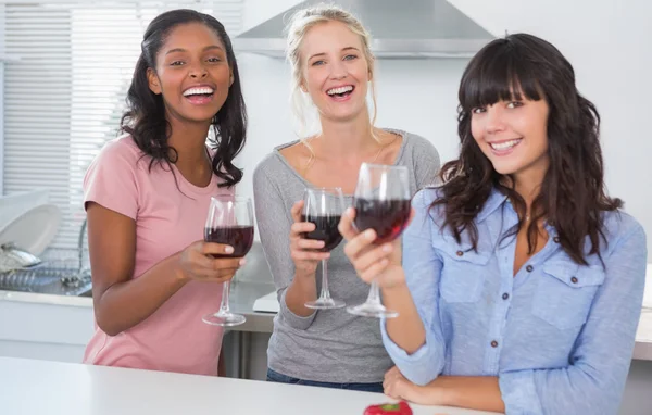 Cheerful friends enjoying glasses of red wine — Stock Photo, Image