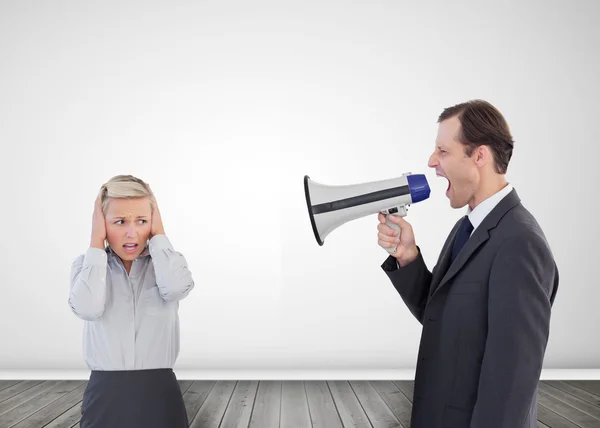 Businessman shouting with a megaphone at his colleague — Stock Photo, Image