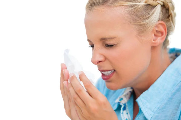 Ill woman sneezing into tissue — Stock Photo, Image