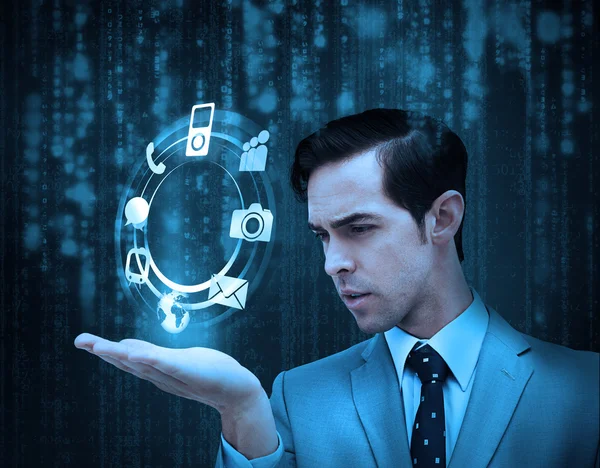 Businessman holding a hologram with smartphone applications — Stock Photo, Image