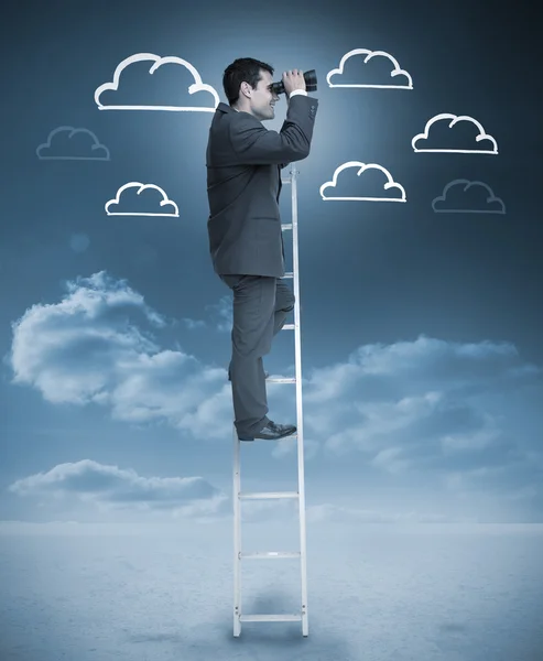 Businessman standing on a ladder over clouds — Stock Photo, Image