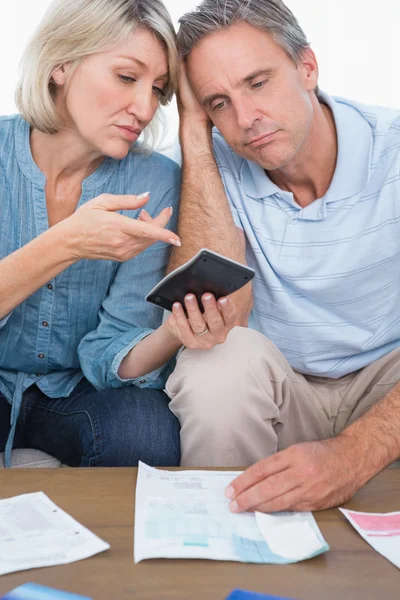 Anxious couple going over their debt — Stock Photo, Image