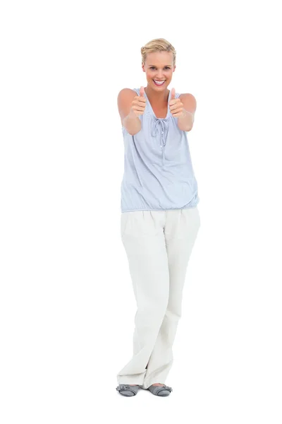 Happy woman standing with thumbs up smiling at camera — Stock Photo, Image