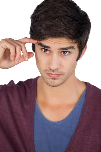 Young man with hand on forehead — Stock Photo, Image