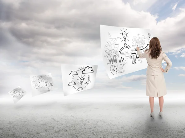 Businesswoman drawing on a paper floating — Stock Photo, Image