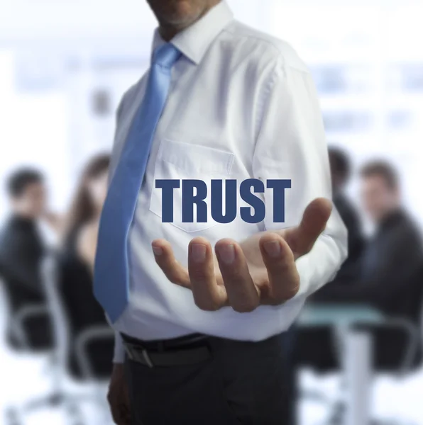 Sophisticated businessman holding the word trust — Stock Photo, Image