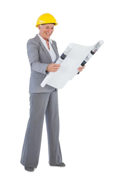 Architect wearing hardhat and looking at plan — Stock Photo, Image