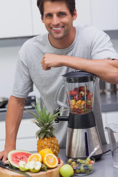 Attractive man leaning on his blender — Stock Photo, Image
