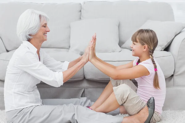 Little girl and grandmother playing together — Stock Photo, Image