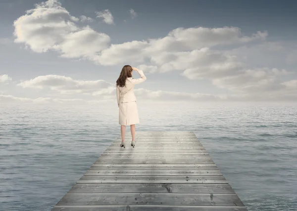 Businesswoman standing on a bridge — Stock Photo, Image