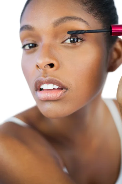 Young woman using mascara for her eyelashes — Stock Photo, Image