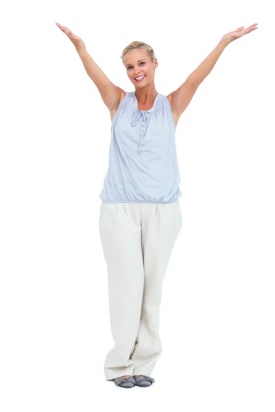 Smiling woman standing with hands up in air — Stock Photo, Image