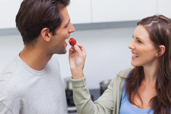Woman feeding her husband cherry tomato — Stock Photo, Image