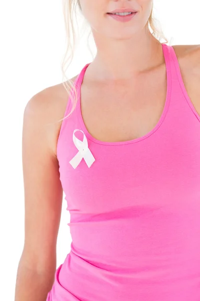 Woman wearing pink top and breast cancer ribbon — Stock Photo, Image