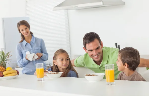 Father speaking to his children who are having breakfast — Stock Photo, Image