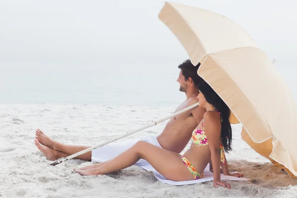 Paar liggen op strandhanddoek op het strand — Stockfoto