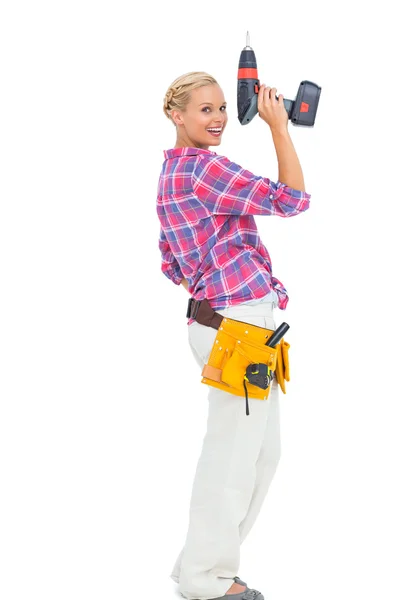 Blonde woman standing holding a drill — Stock Photo, Image