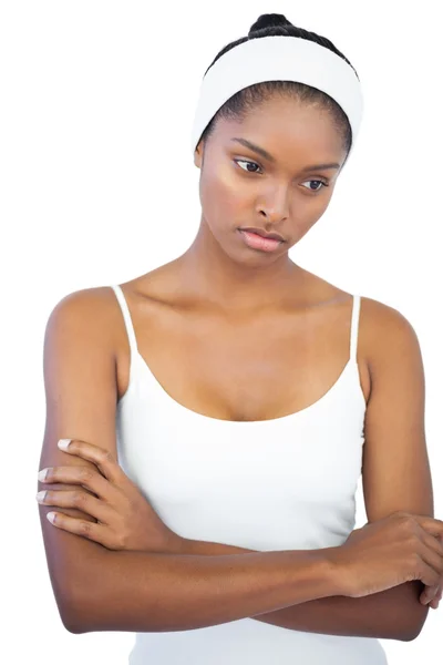 Troubled woman with headband crossing her arms — Stock Photo, Image