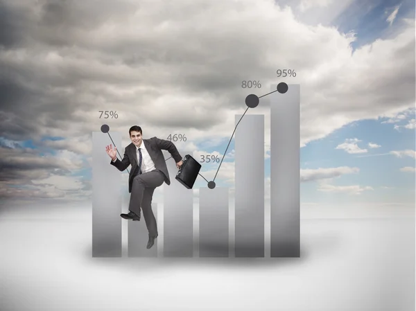 Businessman jumping next to a chart — Stock Photo, Image