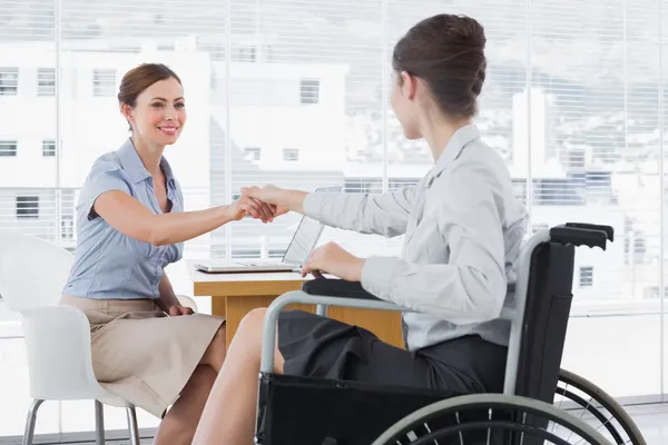 Businesswoman shaking hands with disabled colleague — Stock Photo, Image