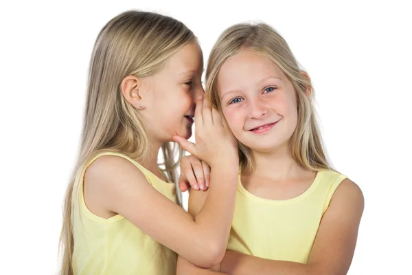 Blondes Mädchen flüstert ihrer Schwester zu — Stockfoto