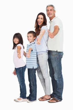 Portrait of a cute family in single file doing thumbs up at came clipart