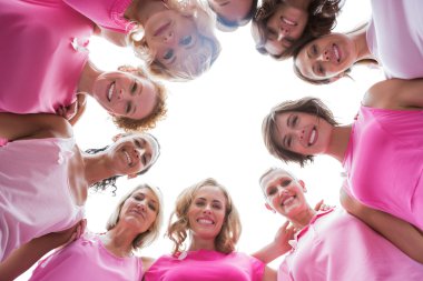 Happy women smiling in circle wearing pink for breast cancer clipart