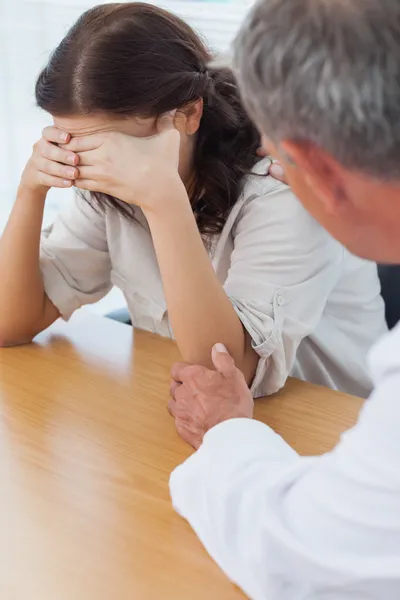 Upset patient crying while doctor comforting her — Stock Photo, Image