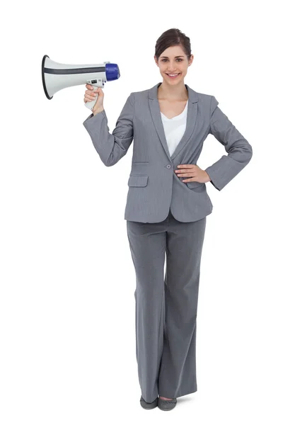 Smiling businesswoman holding loudspeaker — Stock Photo, Image