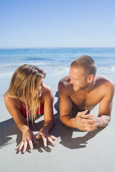 Smiling cute couple in swimsuit posing looking at each other — Stock Photo, Image