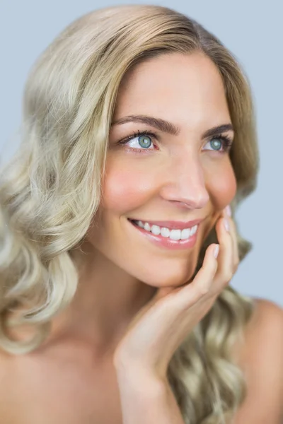 Smiling natural blonde touching her face — Stock Photo, Image