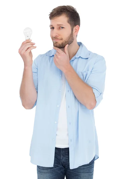 Handsome model holding a bulb — Stok fotoğraf