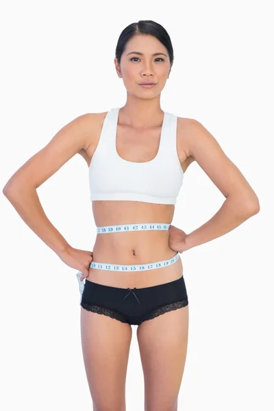 Self confident slim woman measuring her waist — Stock Photo, Image
