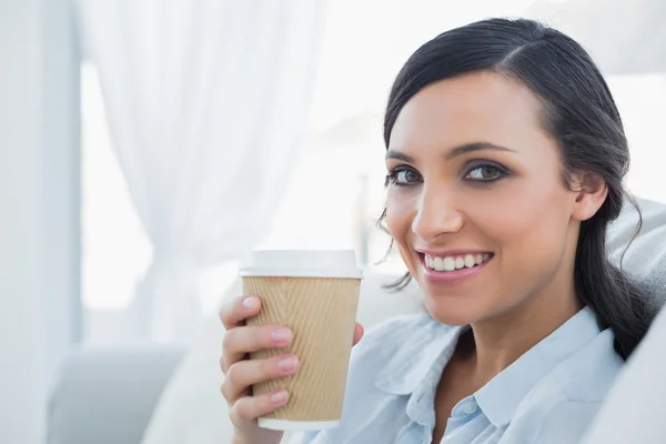 Uśmiechający się kusząca brunetka trzymając kubek kawy — Zdjęcie stockowe