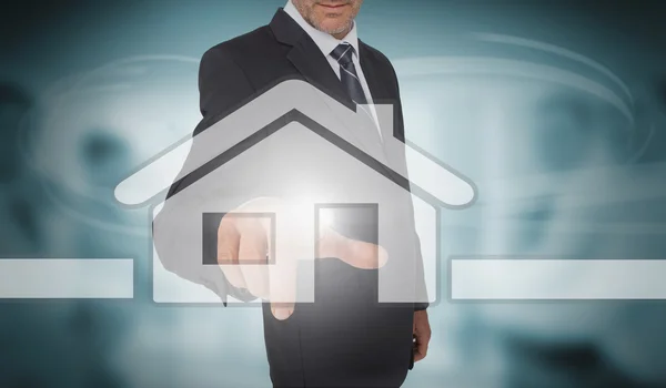 Businessman touching futuristic house interface — Stock Photo, Image