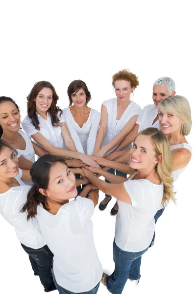 Happy female models joining hands in a circle and looking at cam — Stock Photo, Image