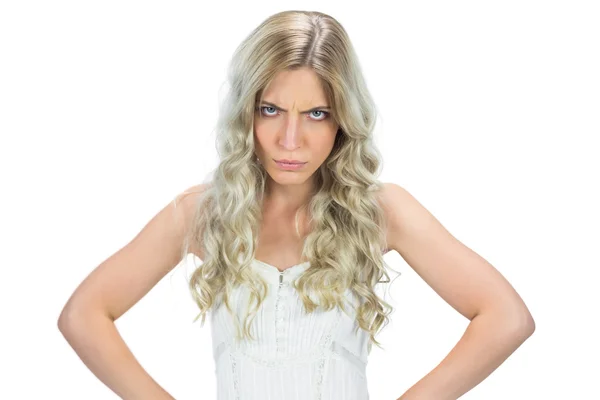 Frowning seductive model in white dress hands on hips — Stock Photo, Image