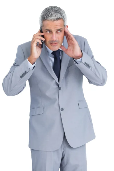 Attentive businessman answering phone — Stock Photo, Image