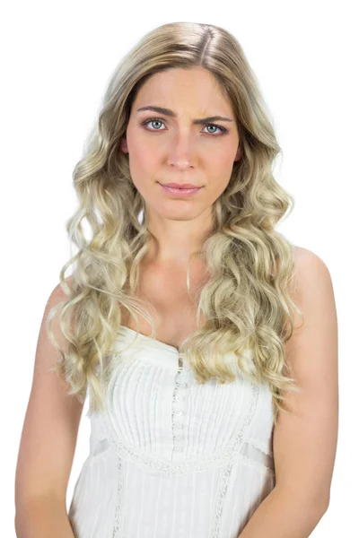 Blond model in white dress rising her eyebrow — Stock Photo, Image