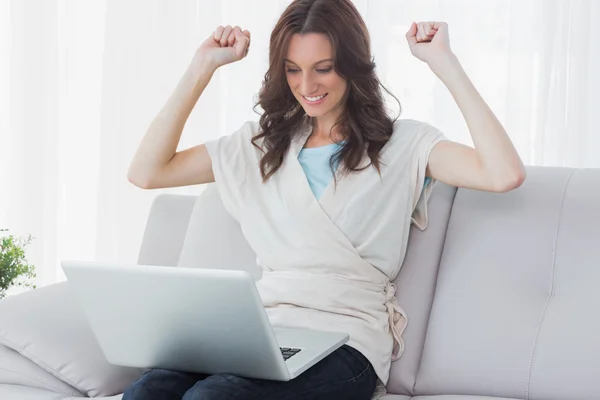 Overjoyed woman looking at her laptop — Stock Photo, Image