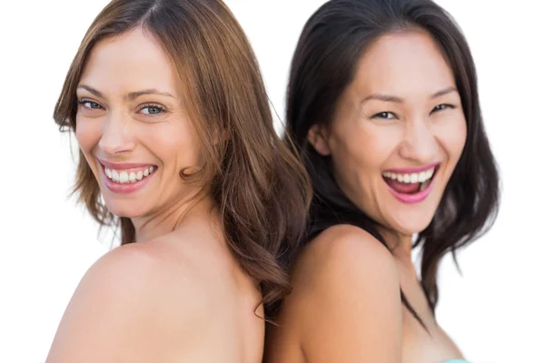 Laughing beautiful nude models posing back to back — Stock Photo, Image