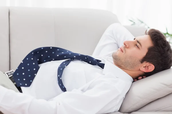 Businessman lying on sofa — Stock Photo, Image