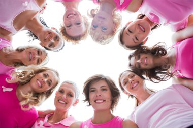 Group of happy women in circle wearing pink for breast cancer clipart
