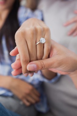 Close up of engagement ring on womans hand clipart