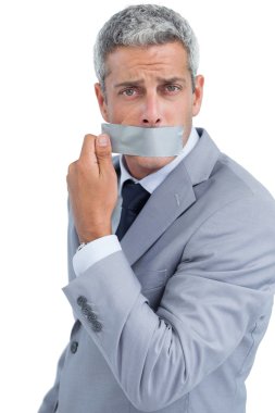 Businessman taking off duct tape on mouth clipart
