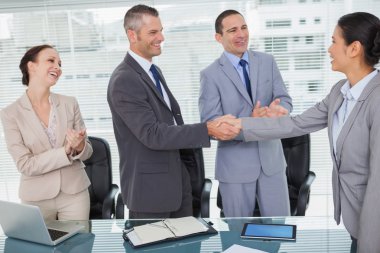 Smiling future workmates shaking hands clipart