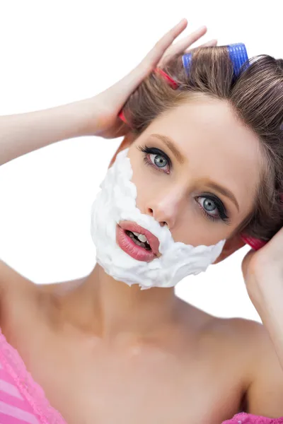 Curious model in hair curlers with shaving foam — Stock Photo, Image