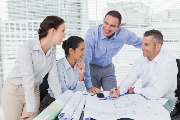 Architects anaylzing plans together — Stock Photo, Image