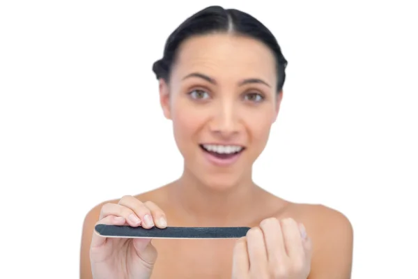 Surprised young model with nail file — Stock Photo, Image